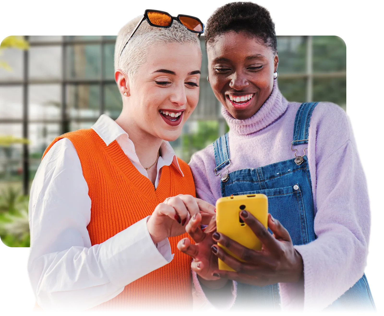 Two attendees looking at a phone together